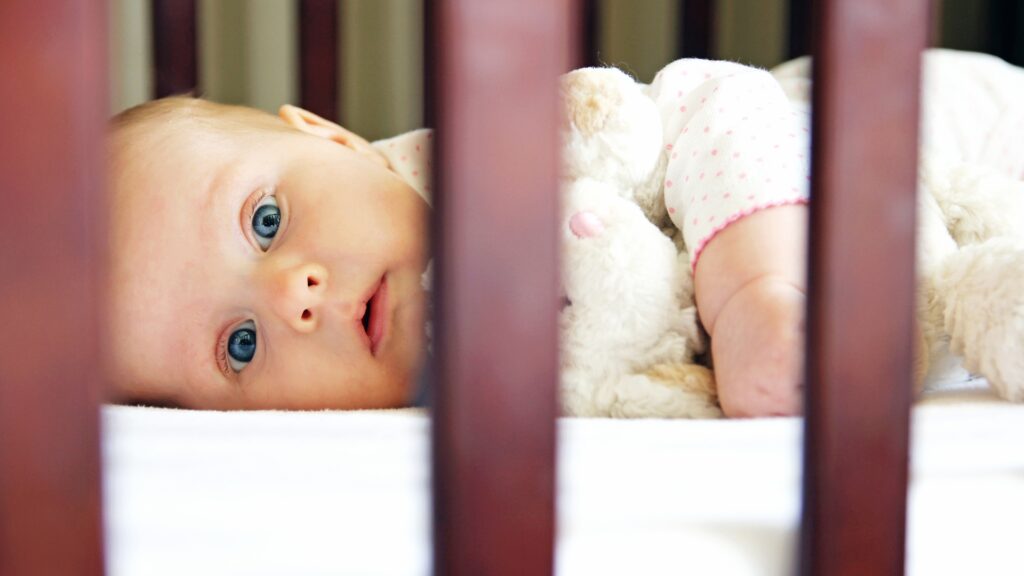 When Do Babies Drop A Nap - Young Baby Wide Awake Lying In Crib On Their Front