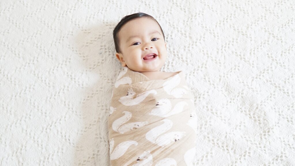 Baby Breaking Out Of Swaddle - Happy Baby Bundled Up